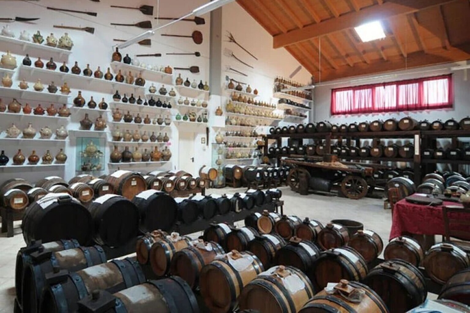 Traditional balsamic vinegar barrels and ceramic bottles at Museo Acetaia Boni in Maranello, Emilia-Romagna
