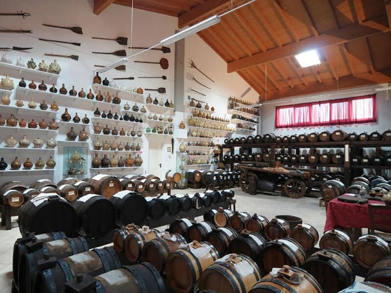 Interior of Acetaia Boni museum with traditional balsamic vinegar barrels, Maranello
