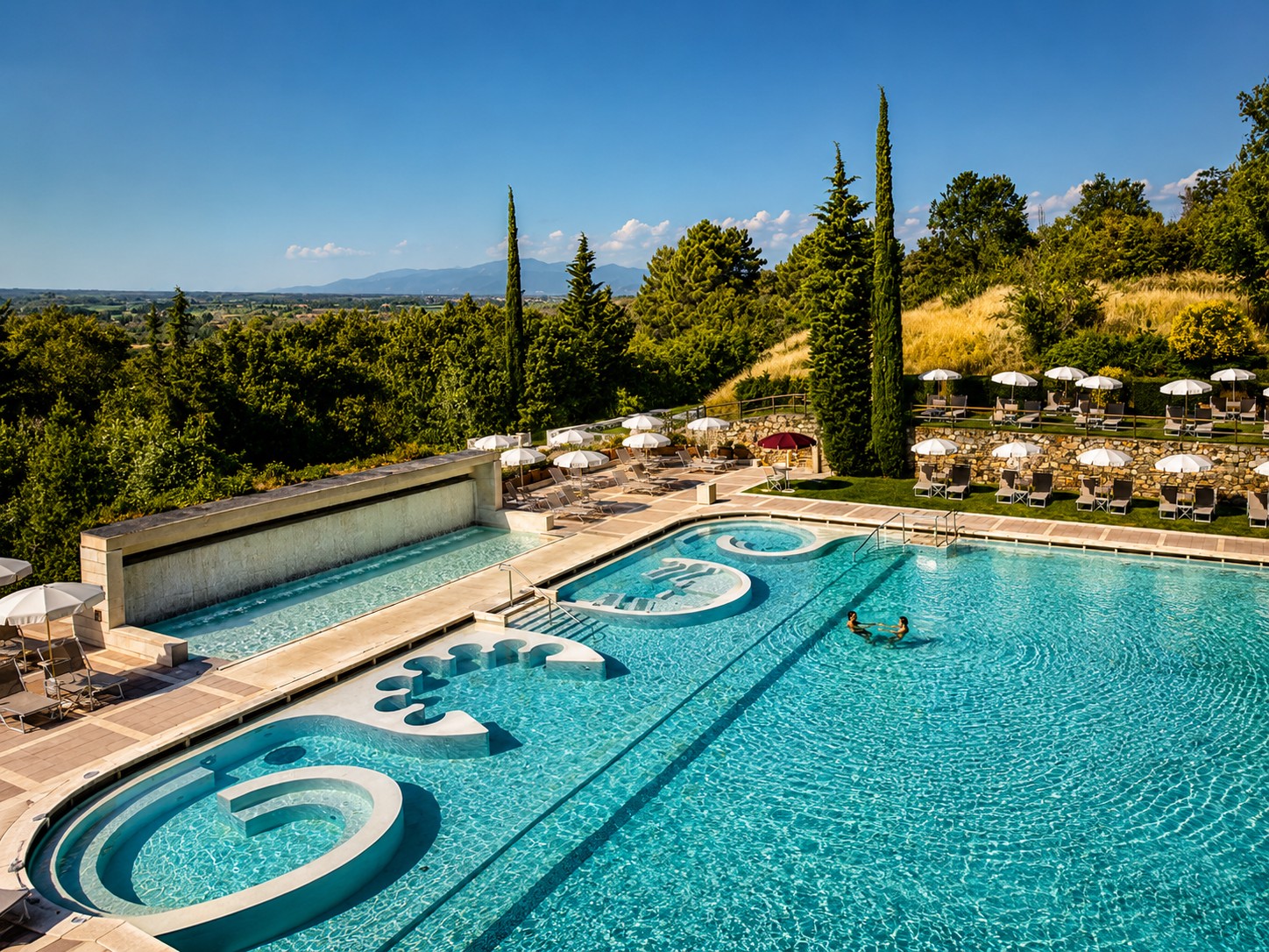 Outdoor thermal pool at Grotta Giusti Spa Resort with Tuscan hills panorama, Monsummano Terme