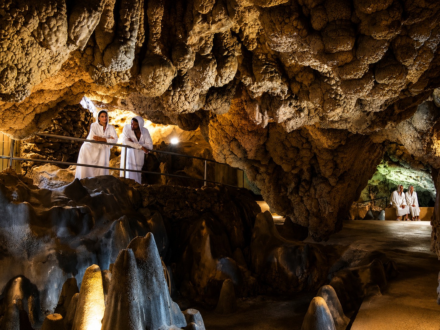 Natural thermal cave with stalactites at Grotta Giusti, guests in white robes, Monsummano Terme Tuscany