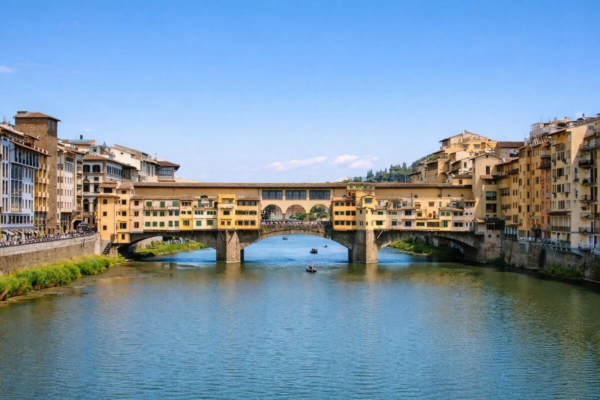 Ponte Vecchio over the Arno River on a sunny day — private chauffeur transfer Florence City Centre