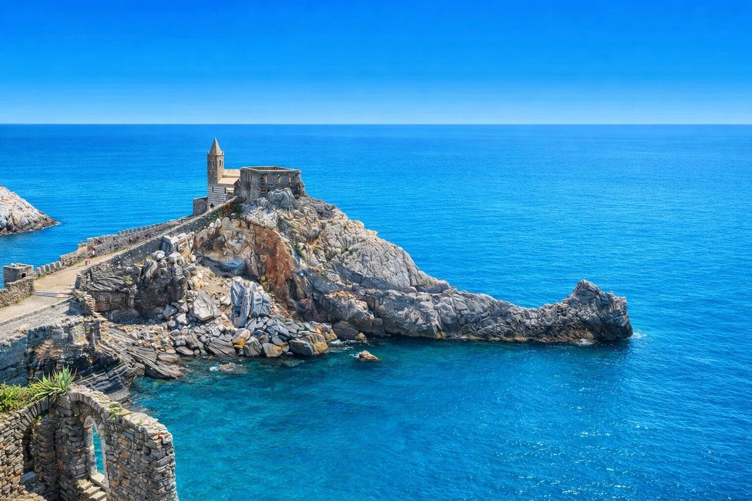Church of San Pietro perched on the rocky headland of Portovenere with turquoise sea, Ligurian coast Italy