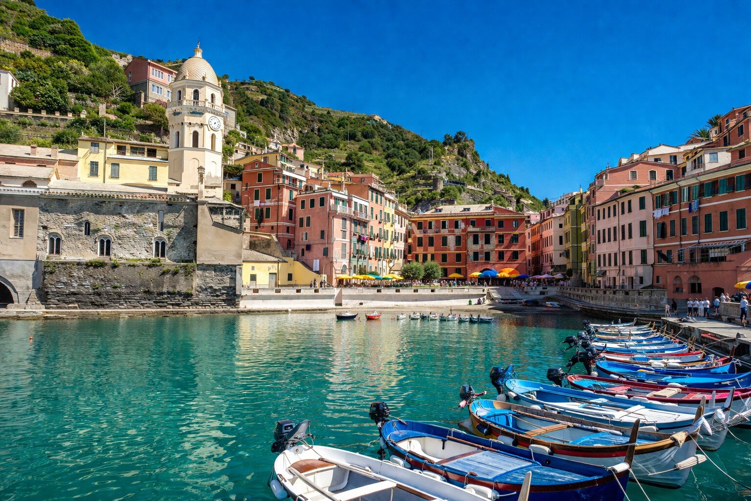 Vernazza harbour with colourful fishing boats and the church bell tower, Cinque Terre Liguria Italy