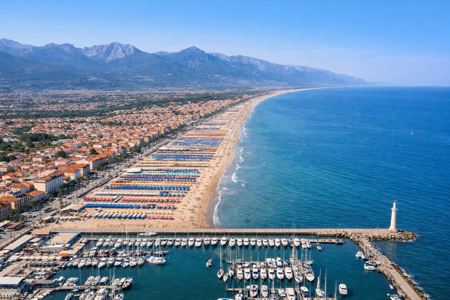 Aerial view of Viareggio beach and marina with Apuan Alps backdrop — private chauffeur transfer Tuscany