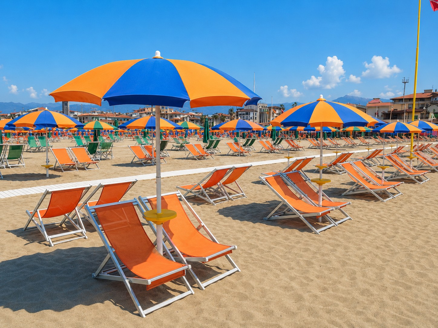 Viareggio beach with orange and blue umbrellas and Apuan Alps in the background — Versilia Riviera Tuscany